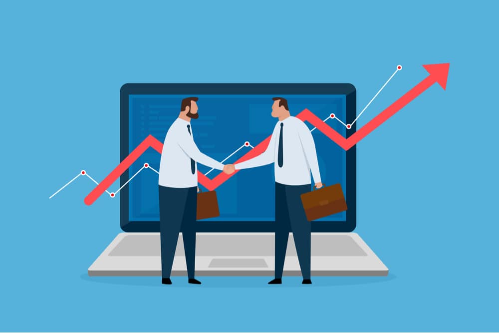illustration of two businessmen shaking hands in front of a laptop