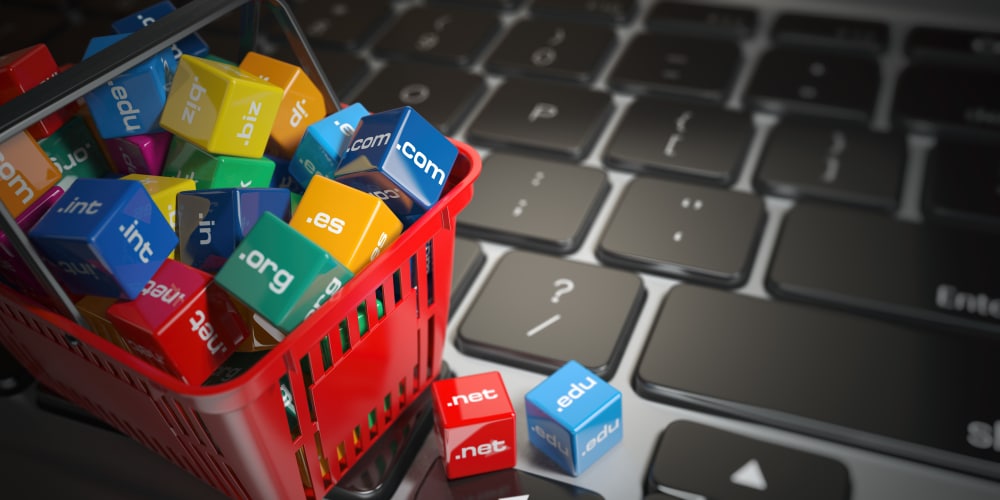shopping basket full of domain name extensions sitting on keyboard